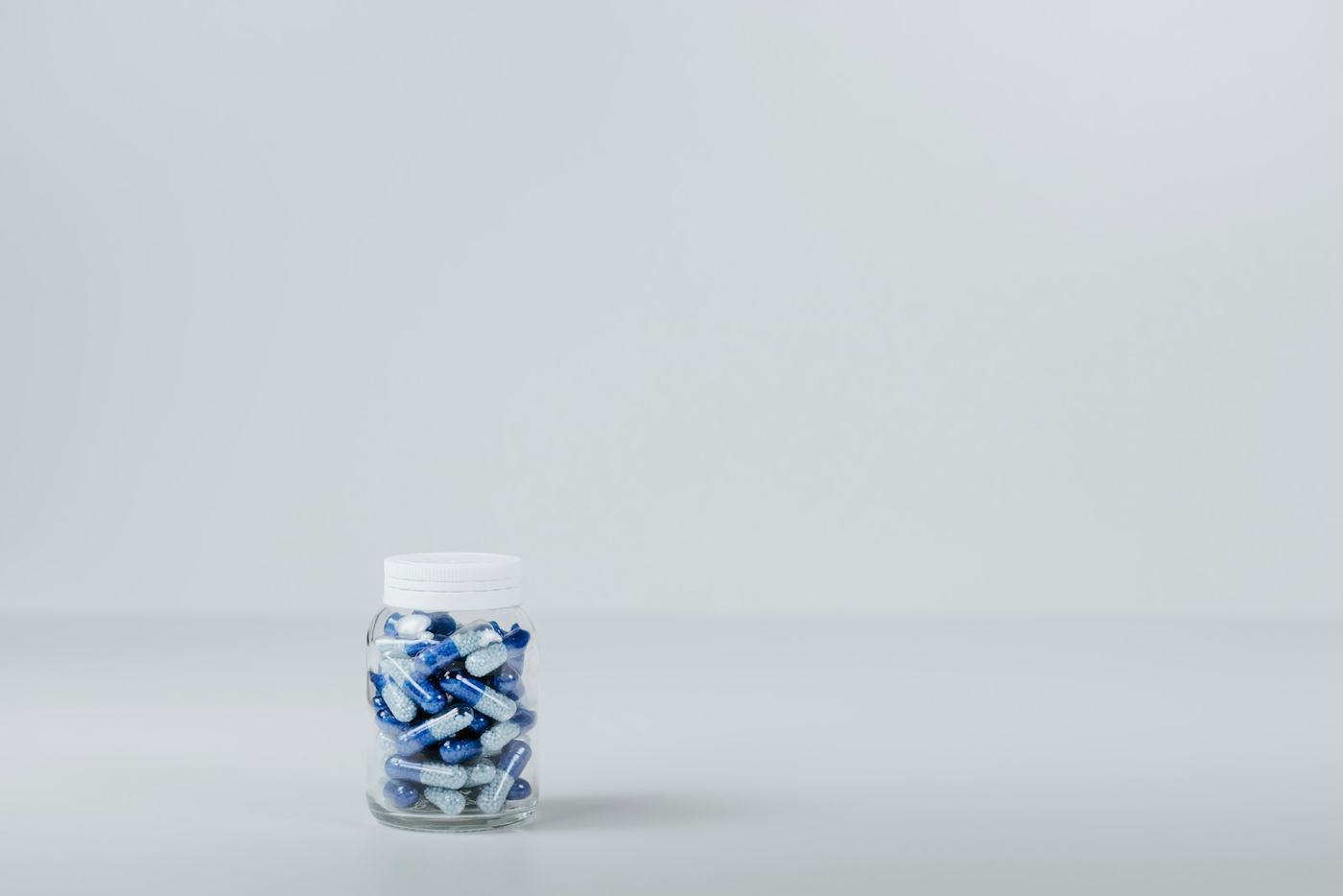 Hand holding a bottle of capsules